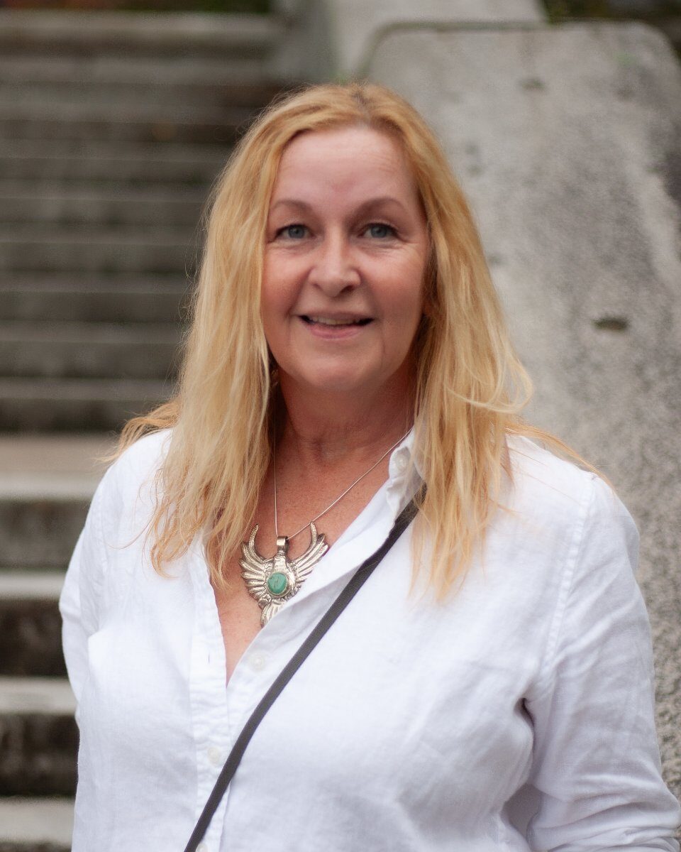 Nora Martini, smiling, in a white shirt